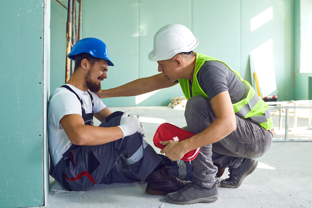 Injured construction worker being consoled by coworker