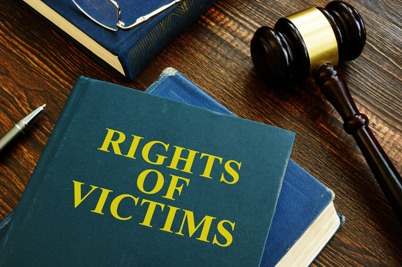 Rights of Victims book and a gavel on a desk